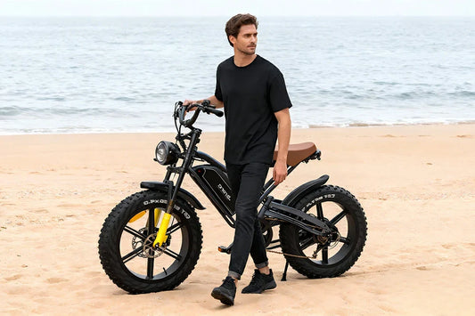 Jansno X50 vintage-style fat-tire e-bike with yellow accents, posed on a sandy beach.