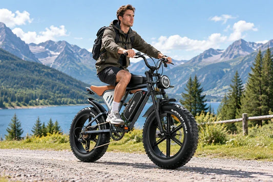 Man riding Jansno X70 retro fat tire electric bike by alpine lake and mountains.