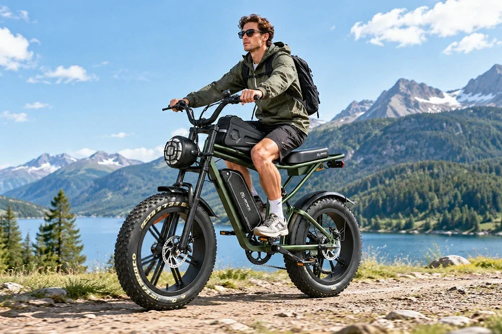 Man riding Jansno X80 retro fat tire electric bike on mountain trail beside alpine lake